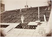 [Workmen on the Paris Opera roof above the stage flytower]