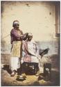 [Turkish street barber with his client]