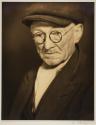 [Man wearing coat and scarf]