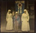 [Two nurses and child dressed  as "Uncle Sam" in WWI Support Parade, Pasadena California]