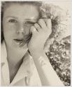 [Woman holding flowers]