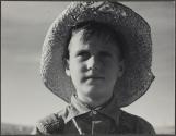 [Boy wearing straw hat]