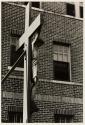[Crucifix in front of brick building]