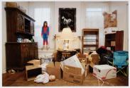 Troy, New York, Six-year-old Katie surveys her family’s possessions as the family prepares them for storage