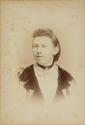 [Woman wearing star-shaped brooch]
