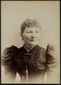 [Woman in dress with large sleeves]