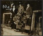 [Three women holding leaves]