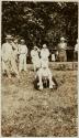 [Man on the ground with others observing]