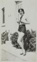 [Woman wearing shorts and high heels]