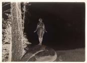 [Woman standing on rock]
