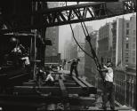 [Unloading trucks with derrick, Empire State building]