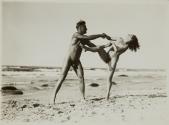 [Man and woman, nude, at beach]