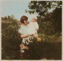 [Woman and baby in garden]