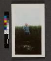 [Young child in tall grass]