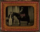 [Two children and horse in front of house]