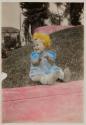 [Baby sitting on grass]