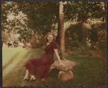 [Woman sitting on rock bench]
