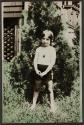 [Young girl in yard]