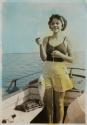 [Woman holding fish on line]