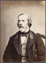 [Seated man with beard]