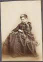 [Woman in frilly bonnet]