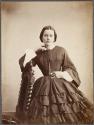 [Woman holding locket]