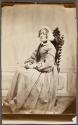 [Woman wearing frilly lace bonnet]
