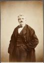 [Man standing with hand in pocket]
