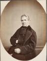 [Man with hand tucked in vest]