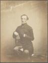 [Man with hand in coat]