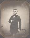 [Man with hand in coat]