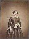[Woman holding book]