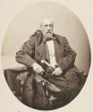 [Seated man holding cane]