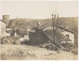 [Village with stone house, cart in yard, church in distance]