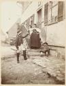 [Soldier, woman and child on stairs]
