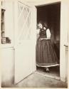[Woman in doorway]
