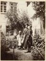 [Soldier with woman and girl in garden]