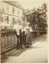 [Man and woman by fence]