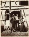 [Two men, woman and child]