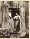 [Two women in doorway]