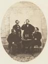 [Four men drinking champagne]