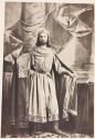 [Man wearing cape and crown]