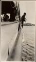 Sailor taking soundings from yacht, Labrador Trip
