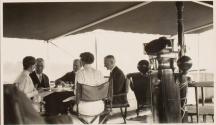 Eastman and party at table on yacht, Labrador Trip