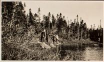 Camping companions on rock near river, Labrador Trip