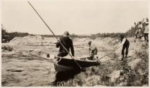 Men poling boat up river rapids, Labrador Trip