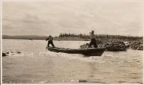 Men poling boat up river rapids, Labrador Trip