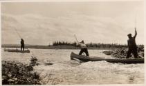 Men poling canoes up river rapids, Labrador Trip