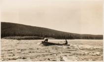 Men poling boat up river rapids, Labrador Trip