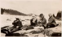 Camping companions with net hats near river, Labrador Trip